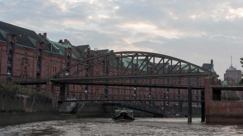 Ansicht einer Barkasse unter einer Brücke in der Hamburger Speicherstadt.
